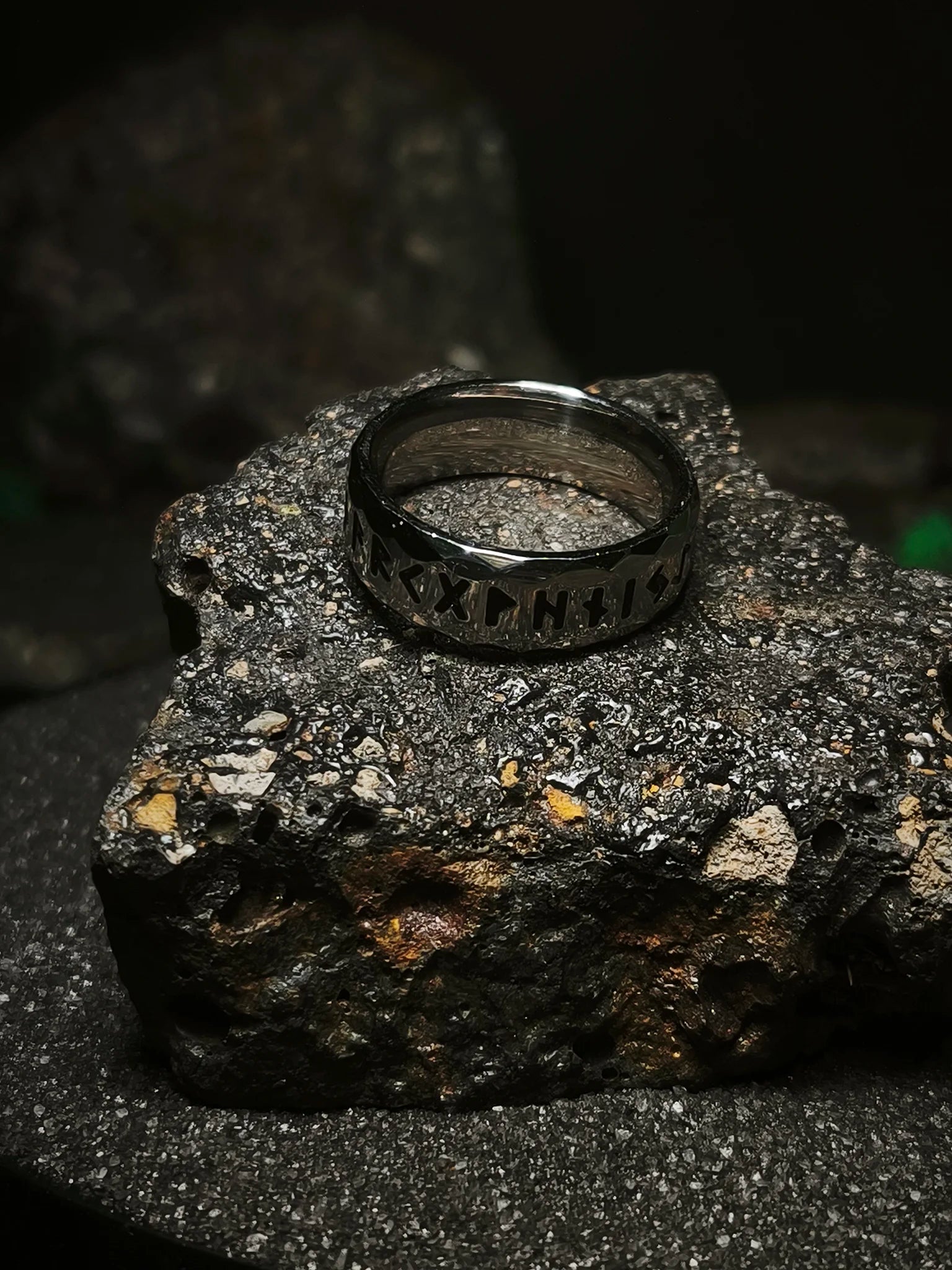 Legado de las Runas: Vista lateral de anillo vikingo facetado con grabado del alfabeto futhark en acero de alta densidad en Chile.